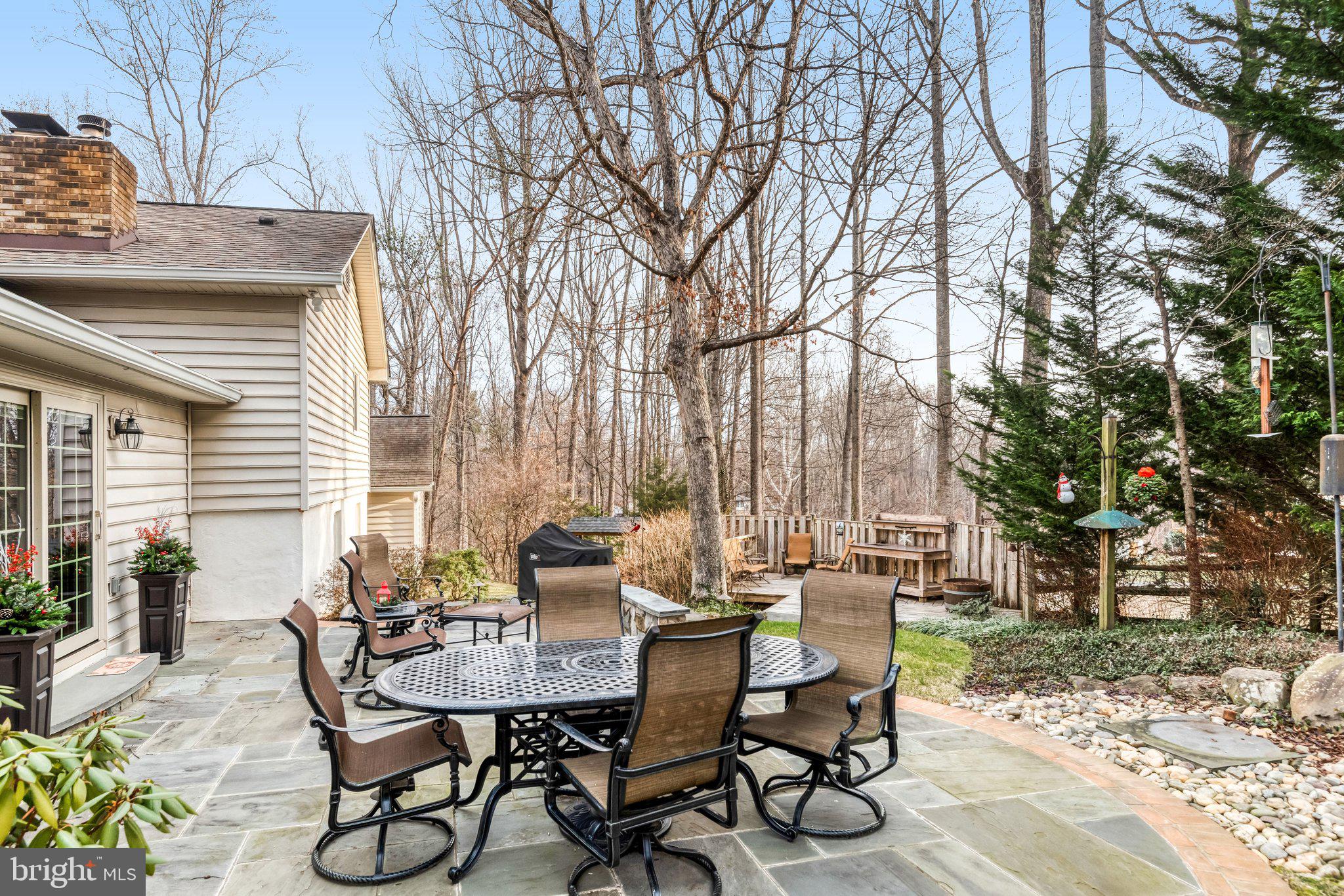 10111 Evans Ford Road Manassas, VA 20111 - Photo 26 of 35 a view of a patio with table and chairs and potted plants