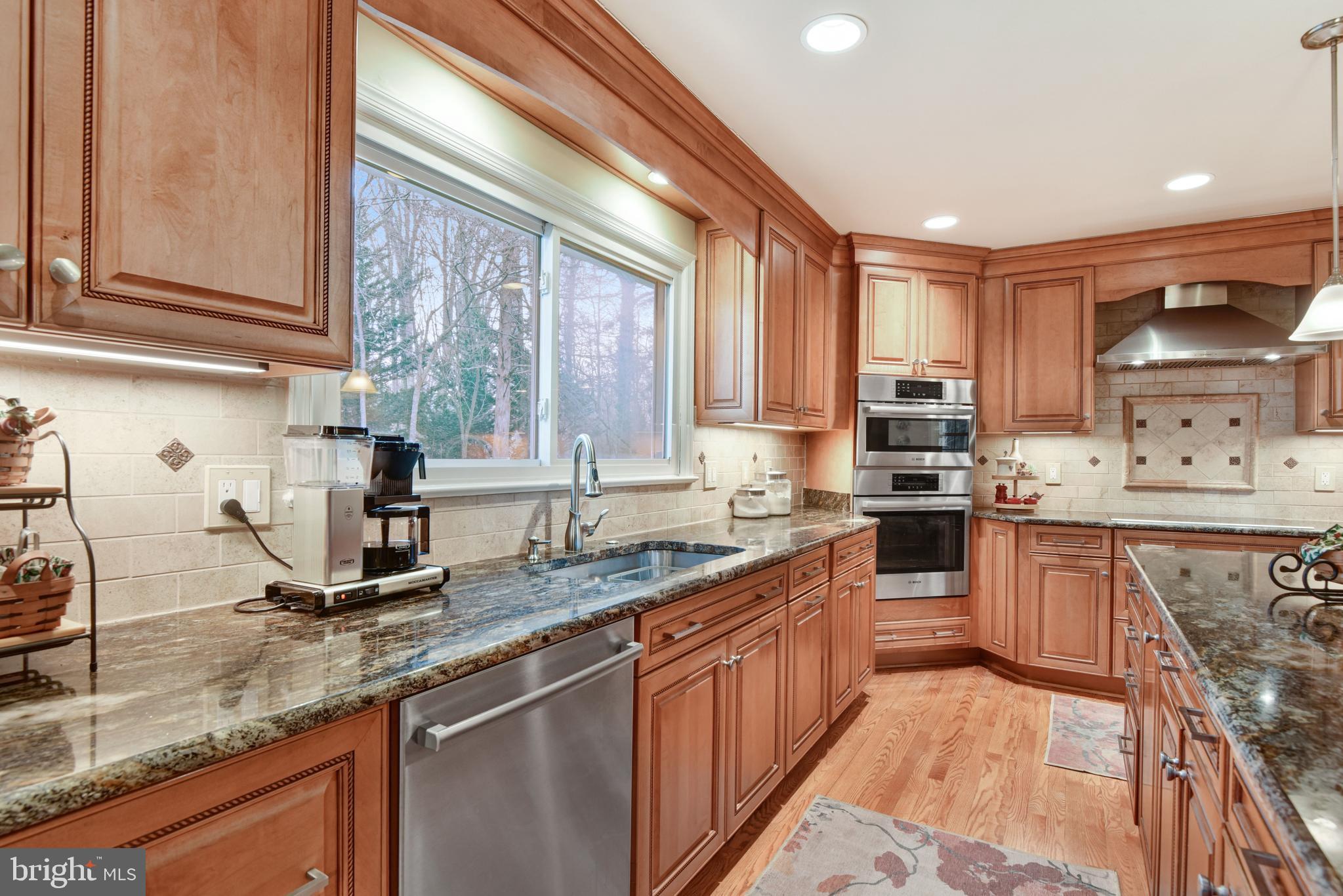 10111 Evans Ford Road Manassas, VA 20111 - Photo 7 of 35 a kitchen with stainless steel appliances granite countertop a sink stove and cabinets