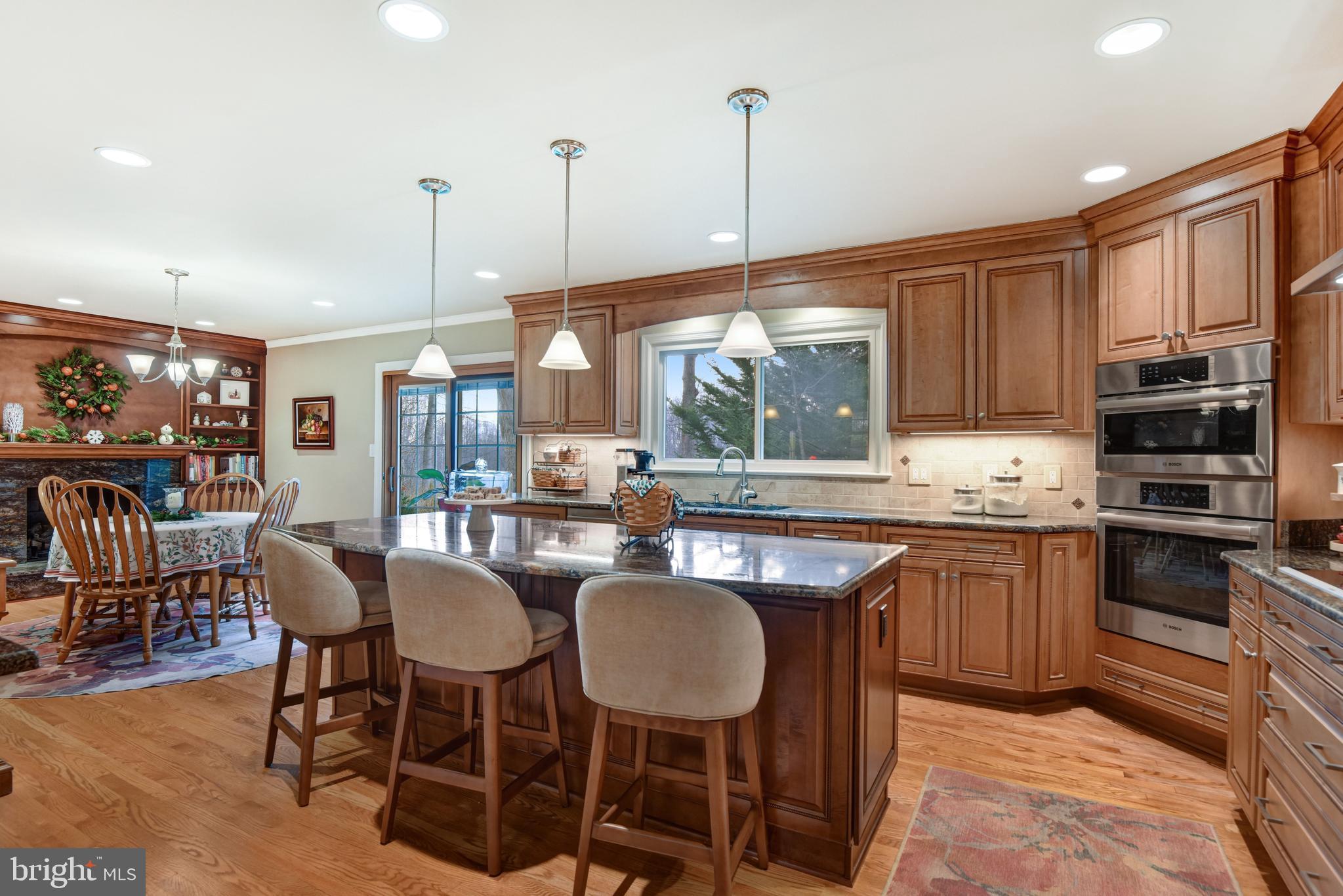 10111 Evans Ford Road Manassas, VA 20111 - Photo 9 of 35 a kitchen with stainless steel appliances granite countertop a table chairs and a wooden cabinets