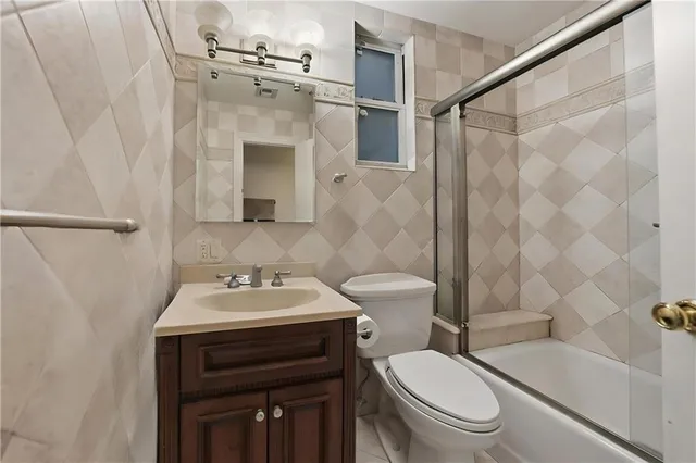 a bathroom with a sink toilet vanity and shower