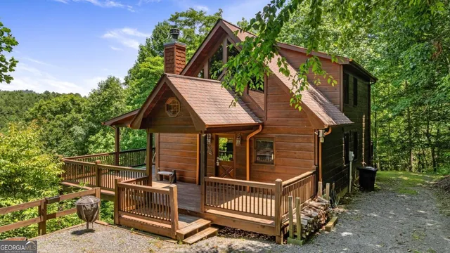 a view of house with a large window and potted plants