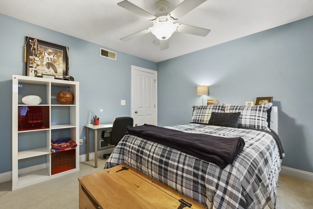 40 Oheir Way Lowell, MA 01852 - Photo 24 of 42 a bedroom with a bed and a chandelier