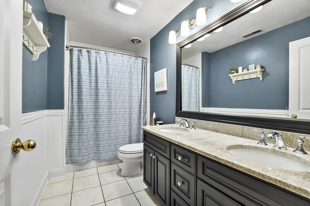40 Oheir Way Lowell, MA 01852 - Photo 26 of 42 a bathroom with a granite countertop sink and a mirror