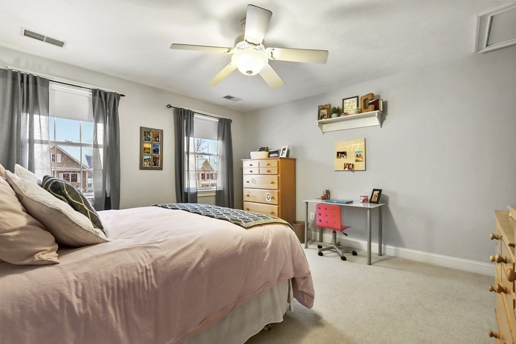 40 Oheir Way Lowell, MA 01852 - Photo 28 of 42 a bedroom with a bed and a chandelier