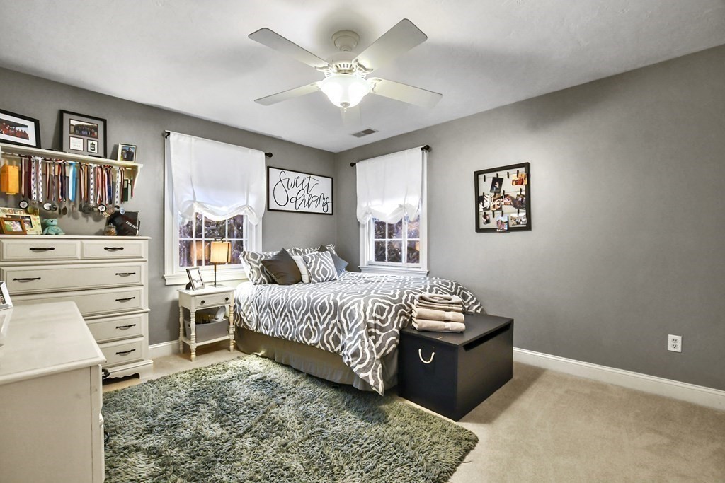 40 Oheir Way Lowell, MA 01852 - Photo 30 of 42 a bedroom with a bed and a chandelier