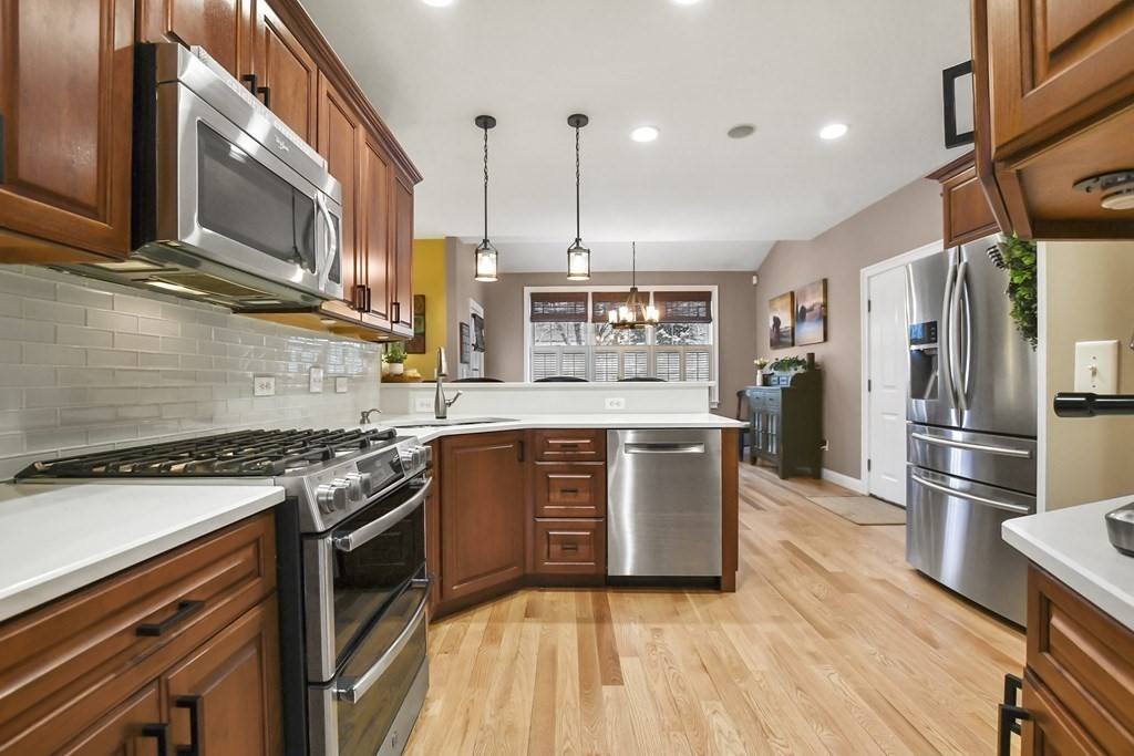 40 Oheir Way Lowell, MA 01852 - Photo 5 of 42 a kitchen with stainless steel appliances granite countertop a stove a sink and a refrigerator