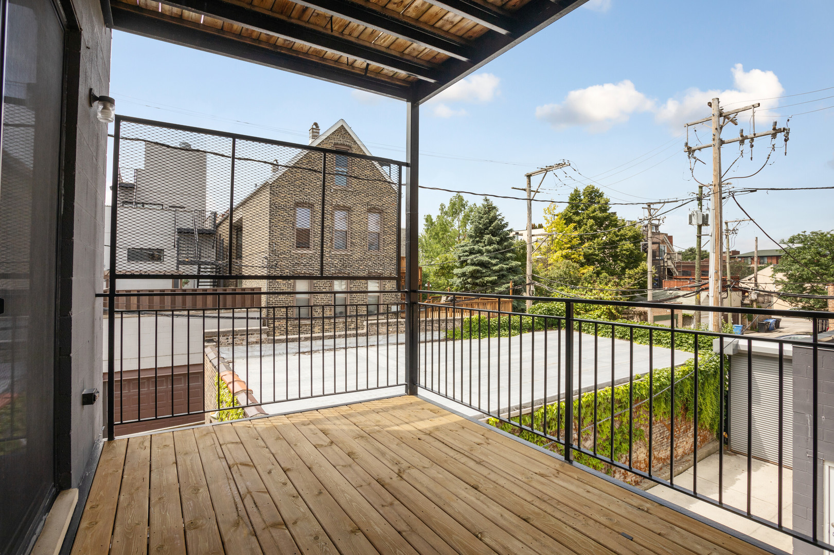854 North May Street, Unit 2S Chicago, IL 60642 - Photo 14 of 16 a view of a balcony with wooden floor