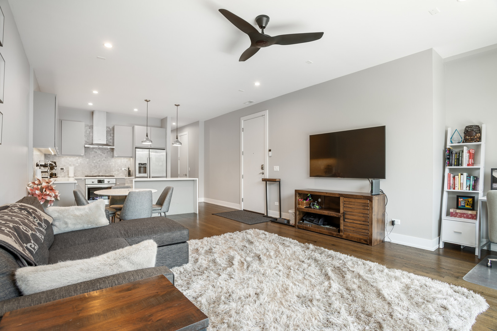 854 North May Street, Unit 2S Chicago, IL 60642 - Photo 2 of 16 a living room with furniture a flat screen tv and a fireplace