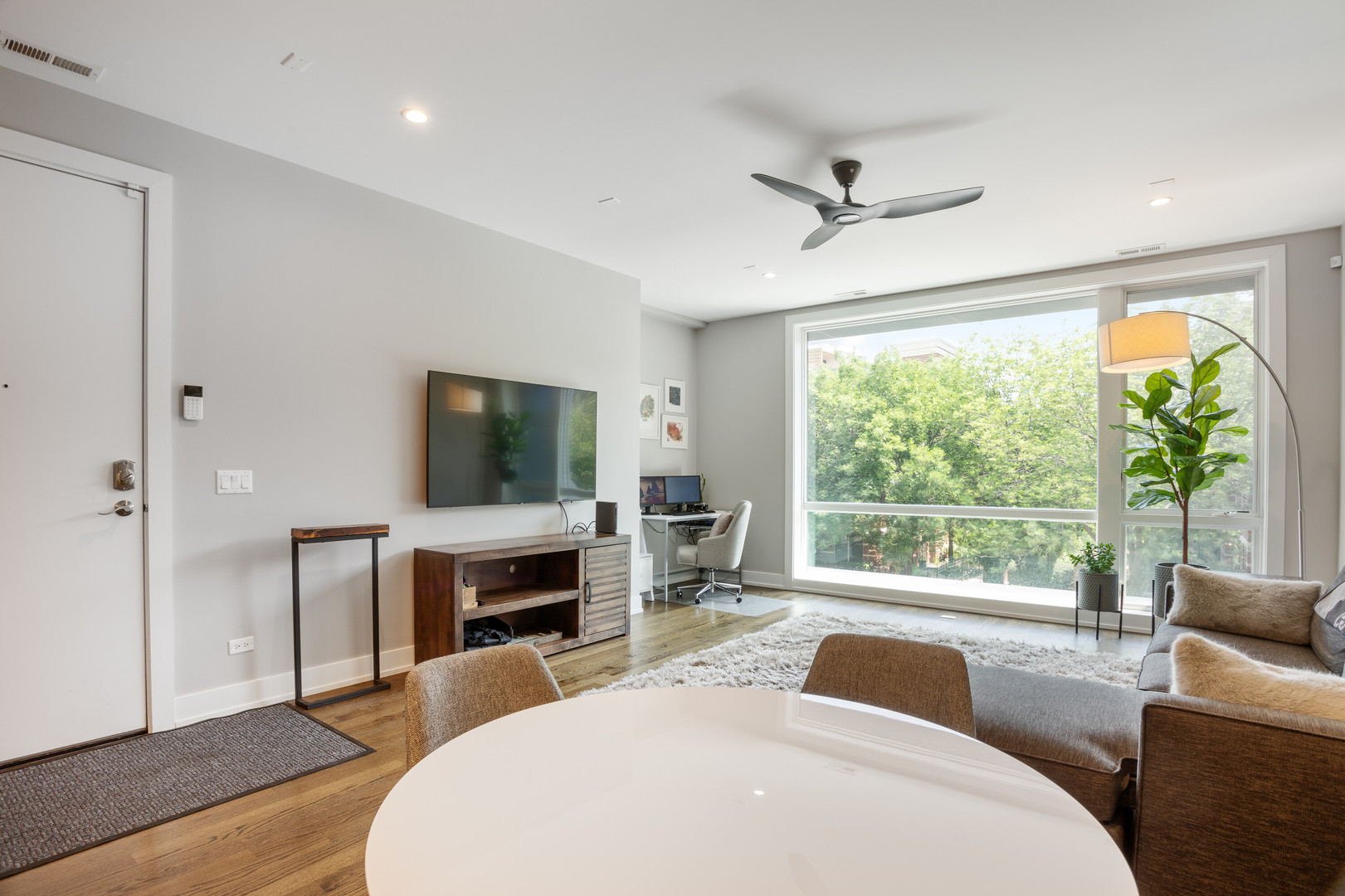 854 North May Street, Unit 2S Chicago, IL 60642 - Photo 4 of 16 a bedroom with a bed and a flat screen tv
