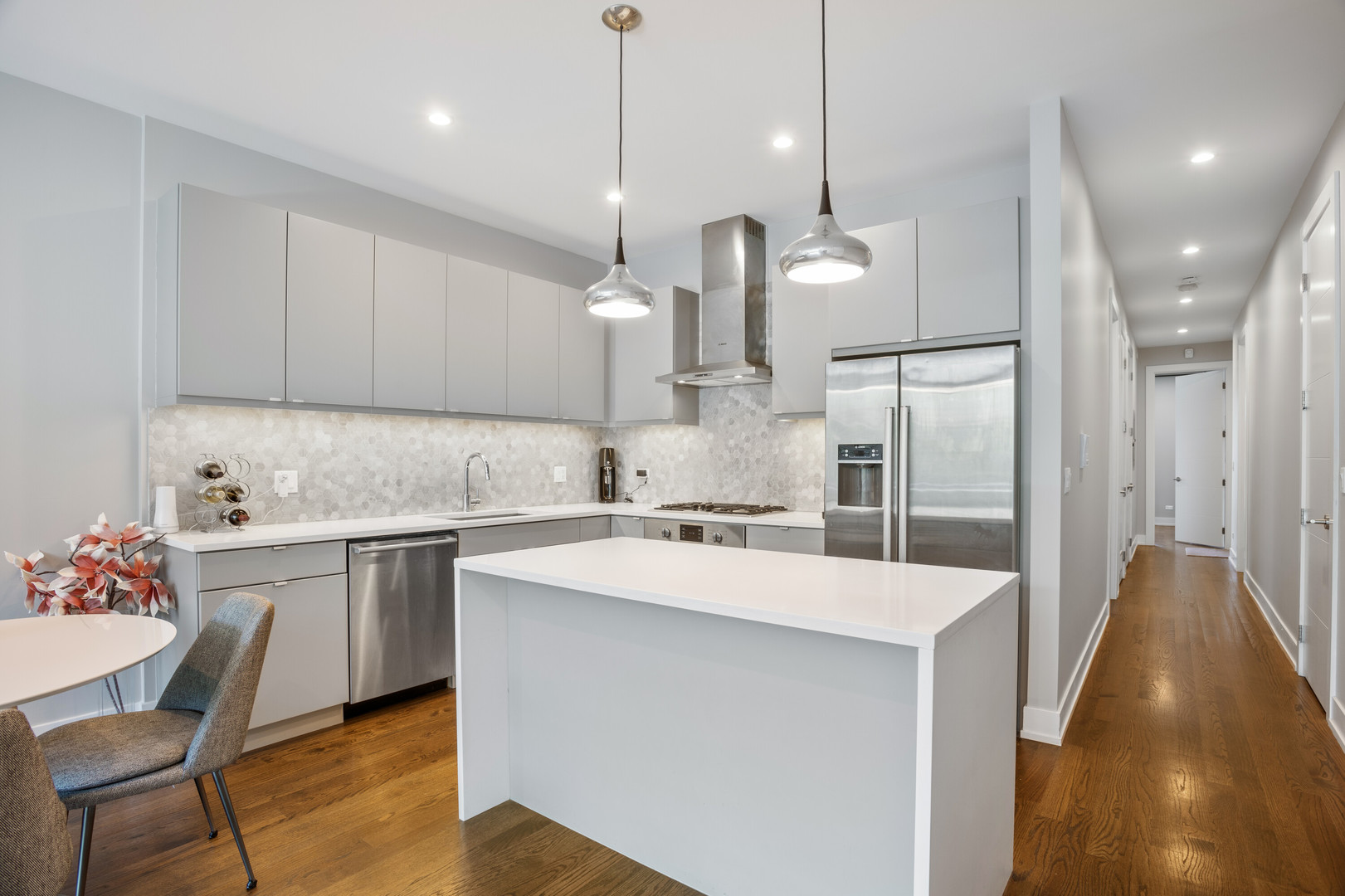 854 North May Street, Unit 2S Chicago, IL 60642 - Photo 7 of 16 a kitchen with a sink a stove a refrigerator and white cabinets