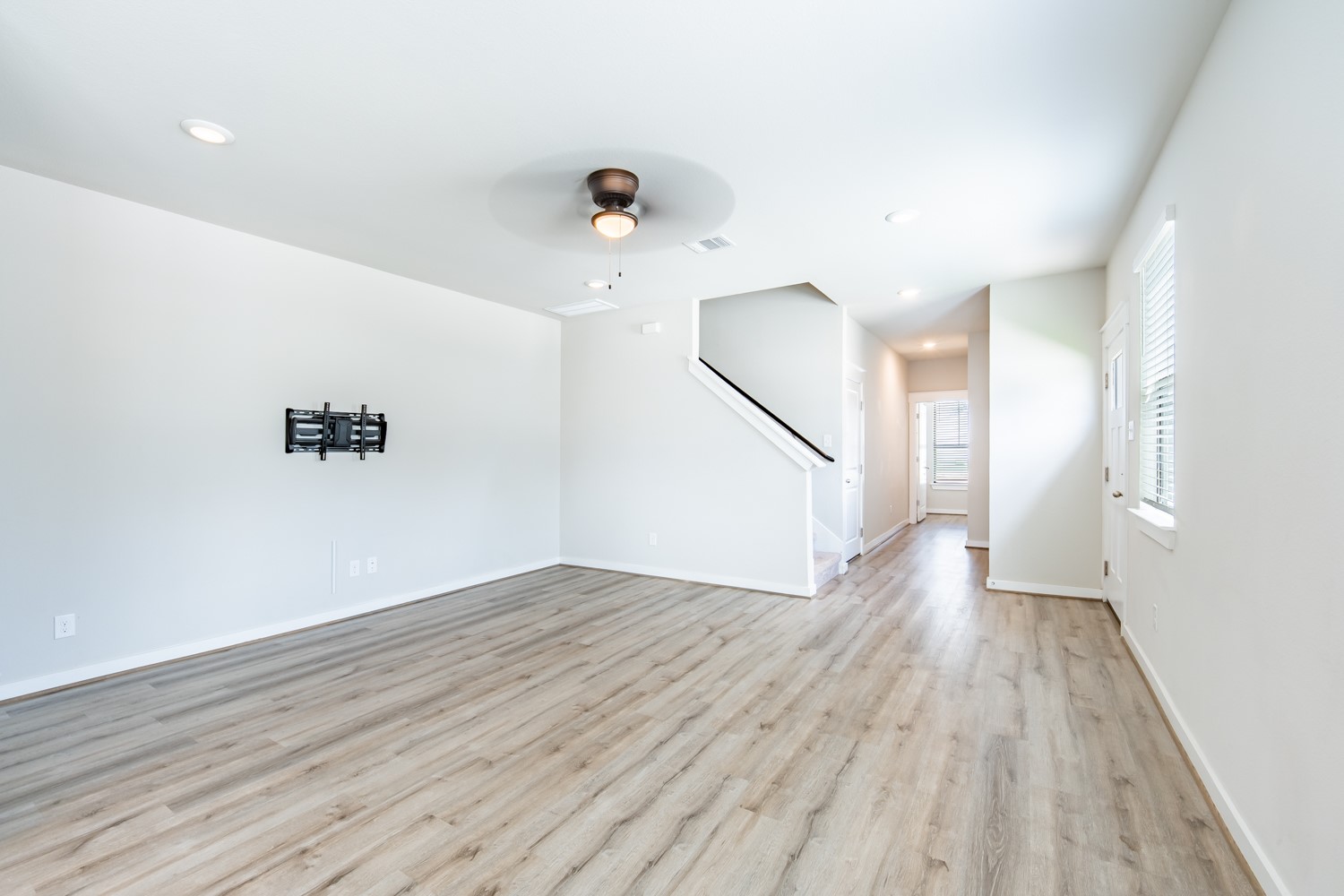 147 Waterside Road, Unit A Buda, TX 78610 - Photo 7 of 27 Luminous living space featuring hardwood-style flooring, ready for your personalized touch.