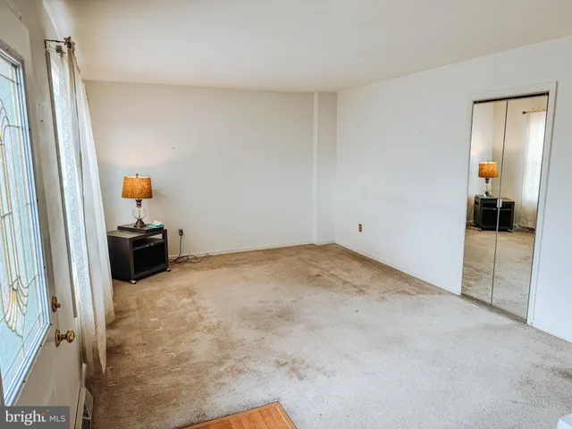 a room with a sink and mirror