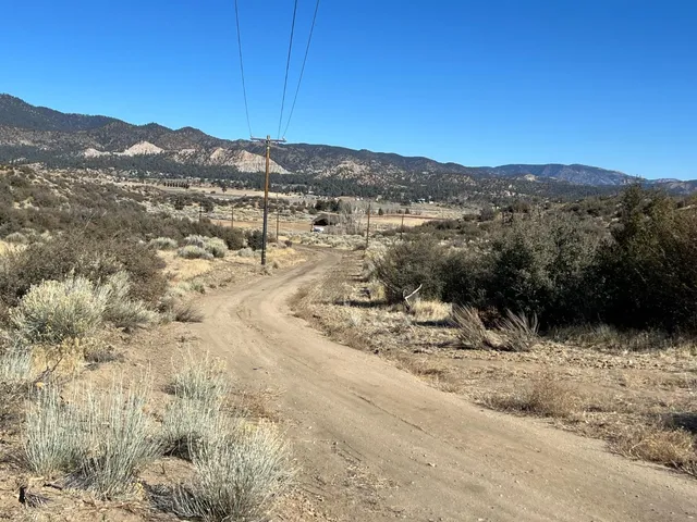 a view of a mountain with a snow in the yard
