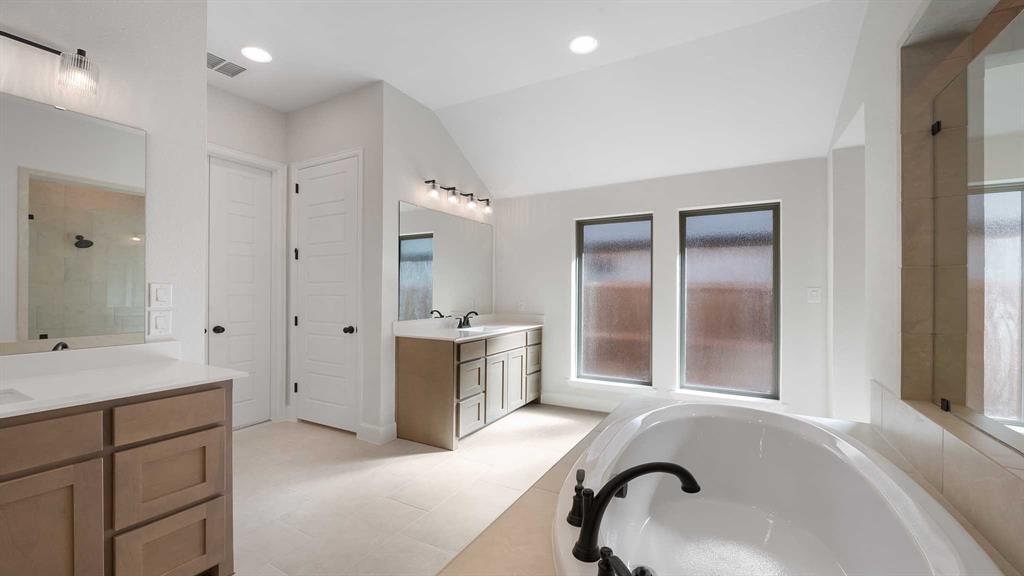 1104 Barnmeadow Lane Forney, TX 75126 - Photo 17 of 33 a bathroom with a sink and a bathtub