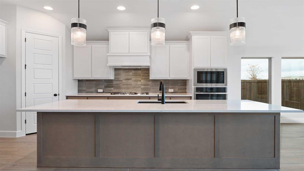 1104 Barnmeadow Lane Forney, TX 75126 - Photo 9 of 33 a kitchen with stainless steel appliances granite countertop a sink a stove and a refrigerator