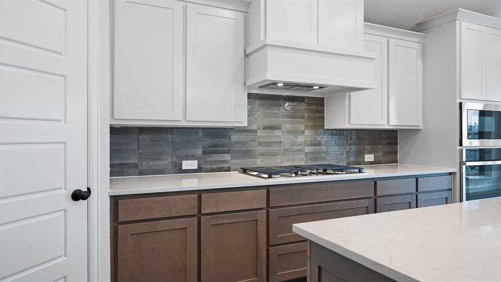 1104 Barnmeadow Lane Forney, TX 75126 - Photo 10 of 33 a kitchen with stainless steel appliances granite countertop a sink a stove and white cabinets