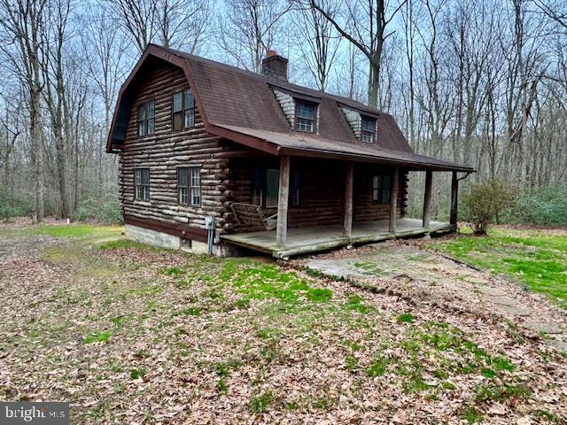 a view of a house with a yard and wooden fence