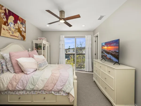a bedroom with a bed and a flat screen tv