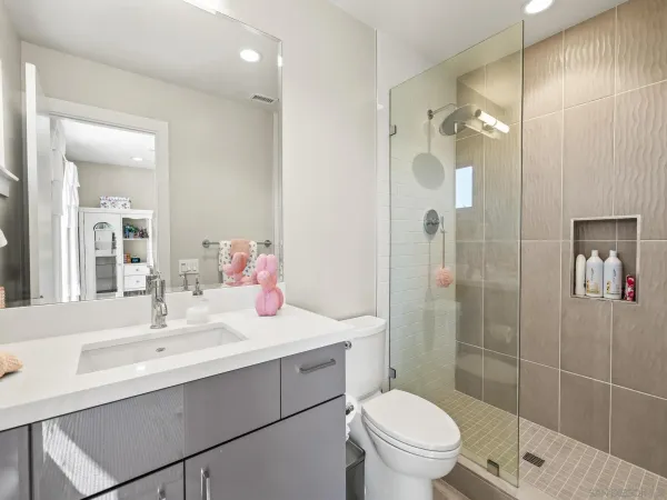 a bathroom with a sink toilet and shower