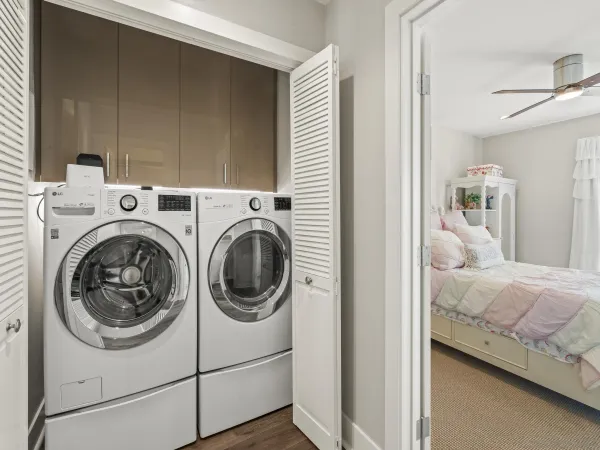 a view of bedroom with washer and dryer