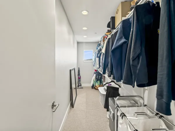 a view of walk in closet with clothes