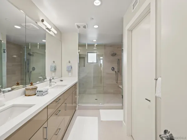 a spacious bathroom with a shower sink and mirror