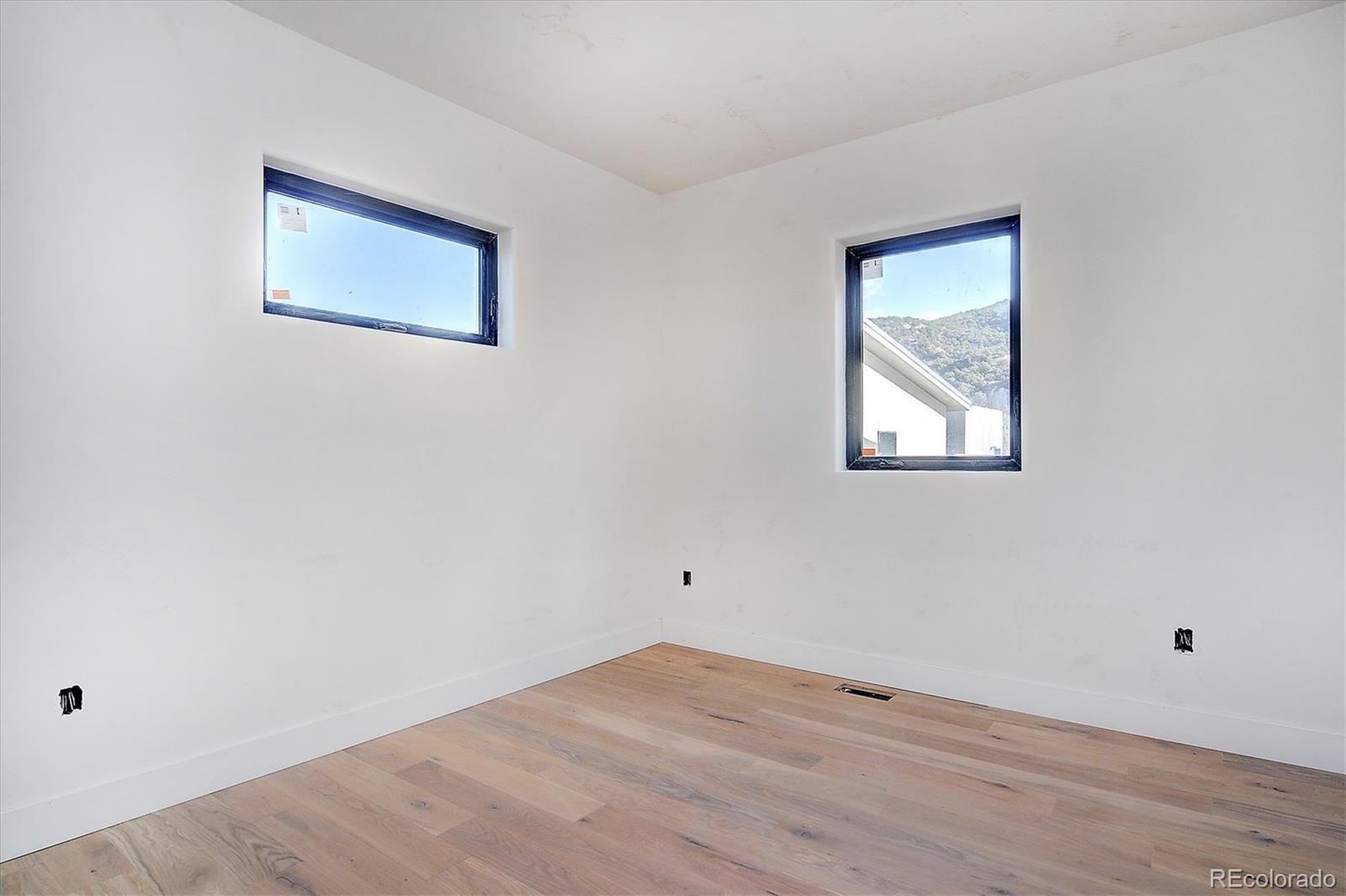 322 Two Rivers Road Salida, CO 81201 - Photo 11 of 18 a view of an empty room with wooden floor and a window