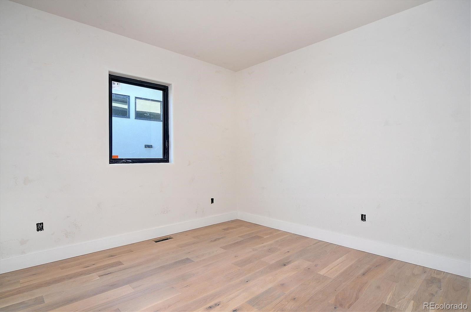 322 Two Rivers Road Salida, CO 81201 - Photo 10 of 18 an empty room with wooden floor and mirror