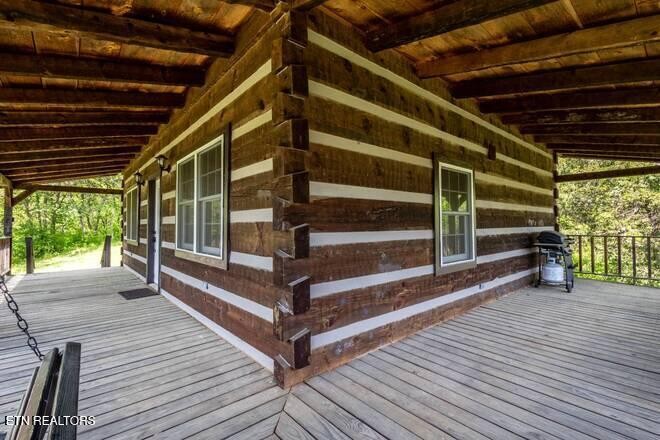 1428 Goodwater Road Bybee, TN 37713 - Photo 15 of 43 a view of an empty room with wooden floor and a window