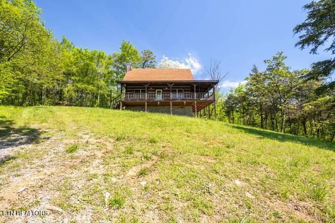 1428 Goodwater Road Bybee, TN 37713 - Photo 17 of 43 a backyard of a house with yard and outdoor seating