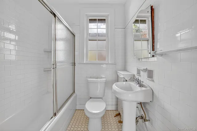 a bathroom with a sink toilet and a mirror