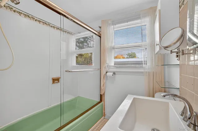 a bathroom with a tub and a sink
