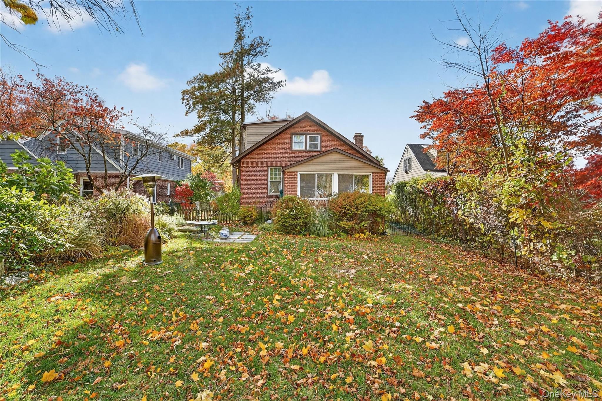 64 Elmore Avenue Croton-on-Hudson, NY 10520 - Photo 36 of 36 Rear view of house featuring a yard, a chimney, and brick siding
