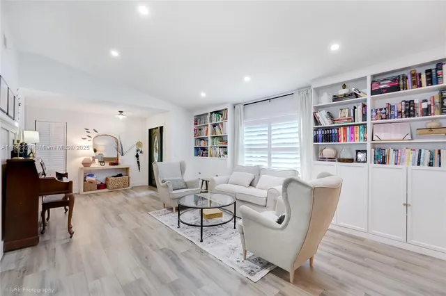 a living room with furniture and a book shelf