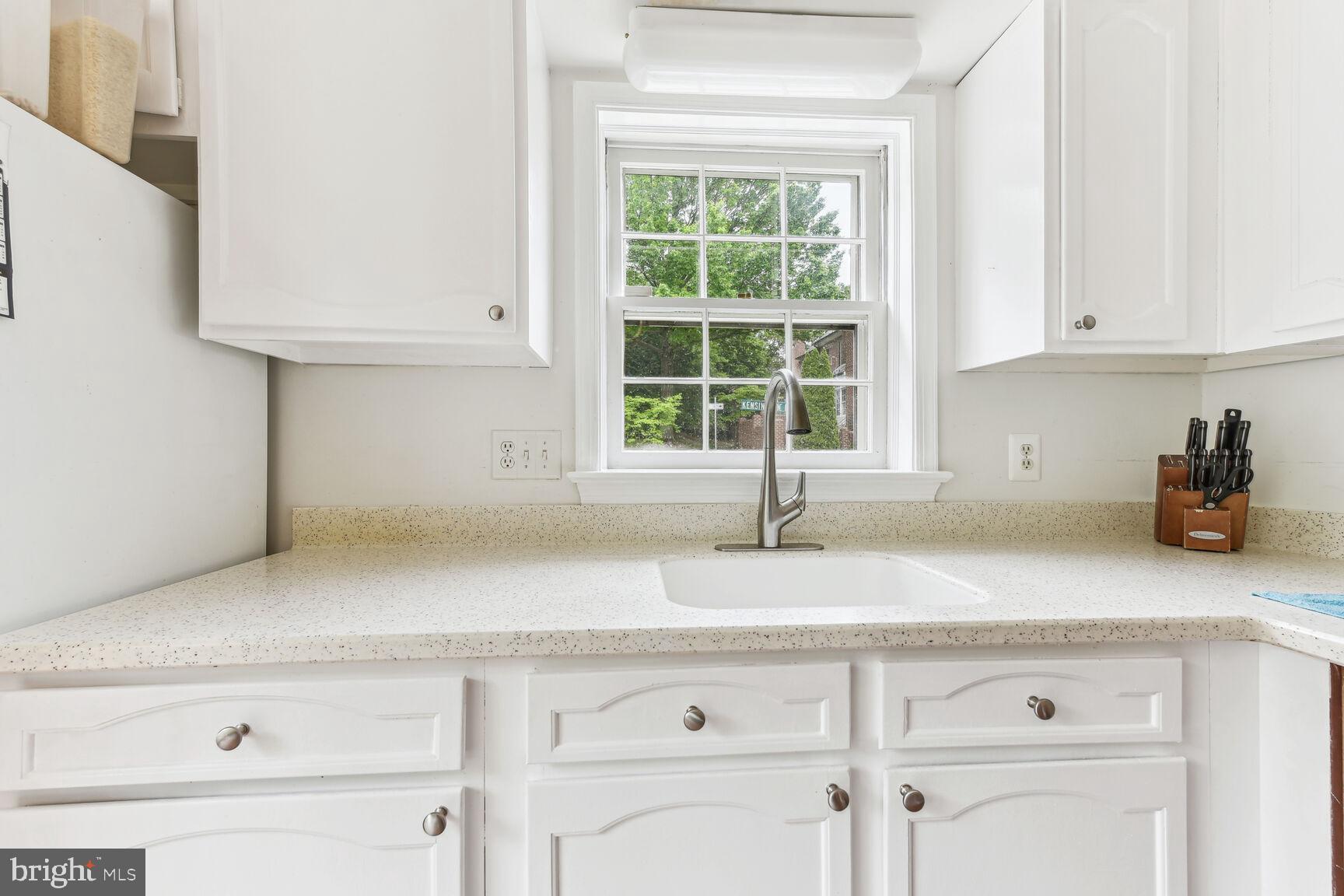 6719 Baron Road McLean, VA 22101 - Photo 11 of 30 a kitchen with granite countertop white cabinets and a window