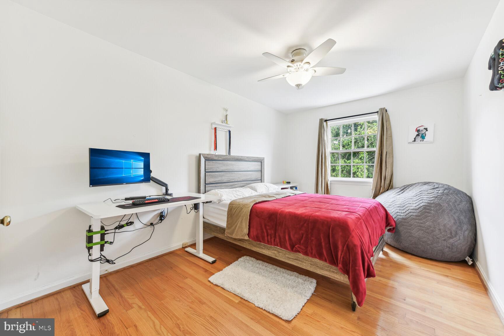 6719 Baron Road McLean, VA 22101 - Photo 17 of 30 a bedroom with a bed and a chandelier