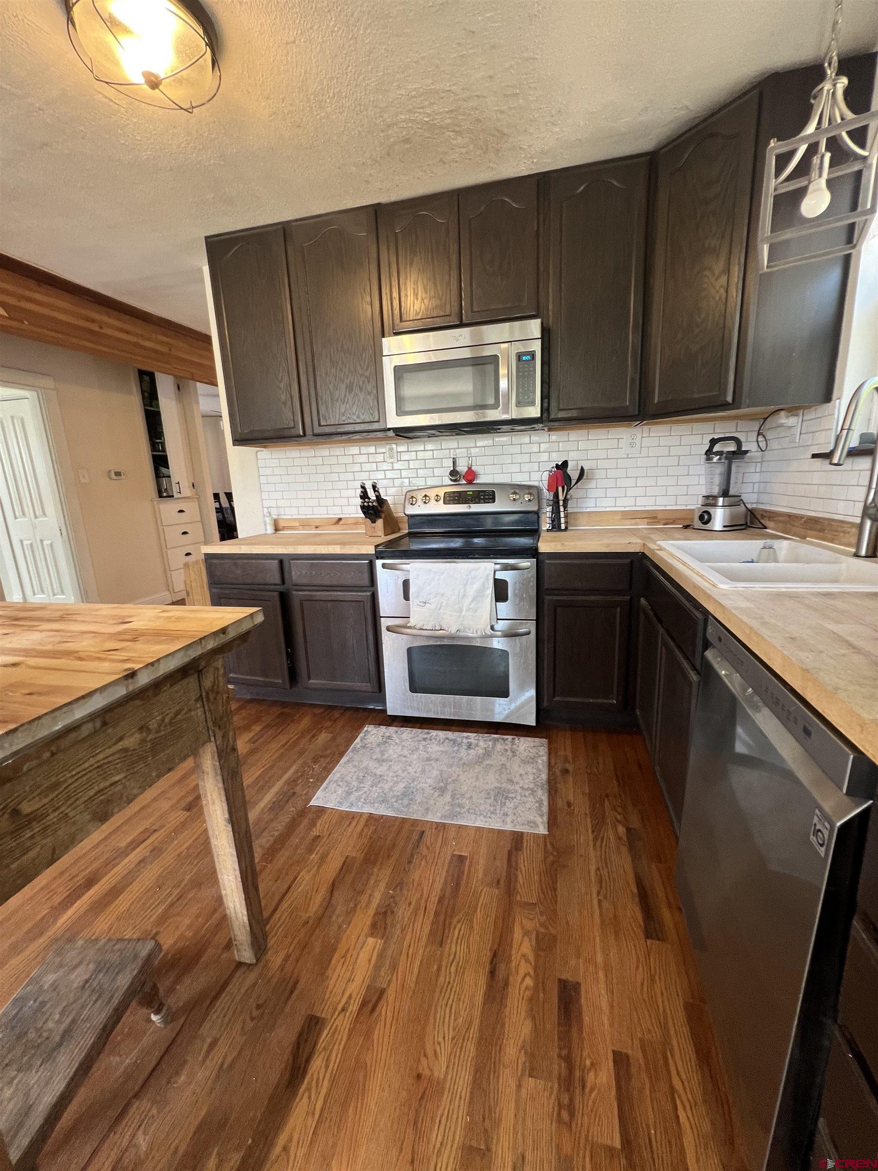 20691 Fairview Road Austin, CO 81410 - Photo 14 of 42 a kitchen with wooden floors and wooden cabinets
