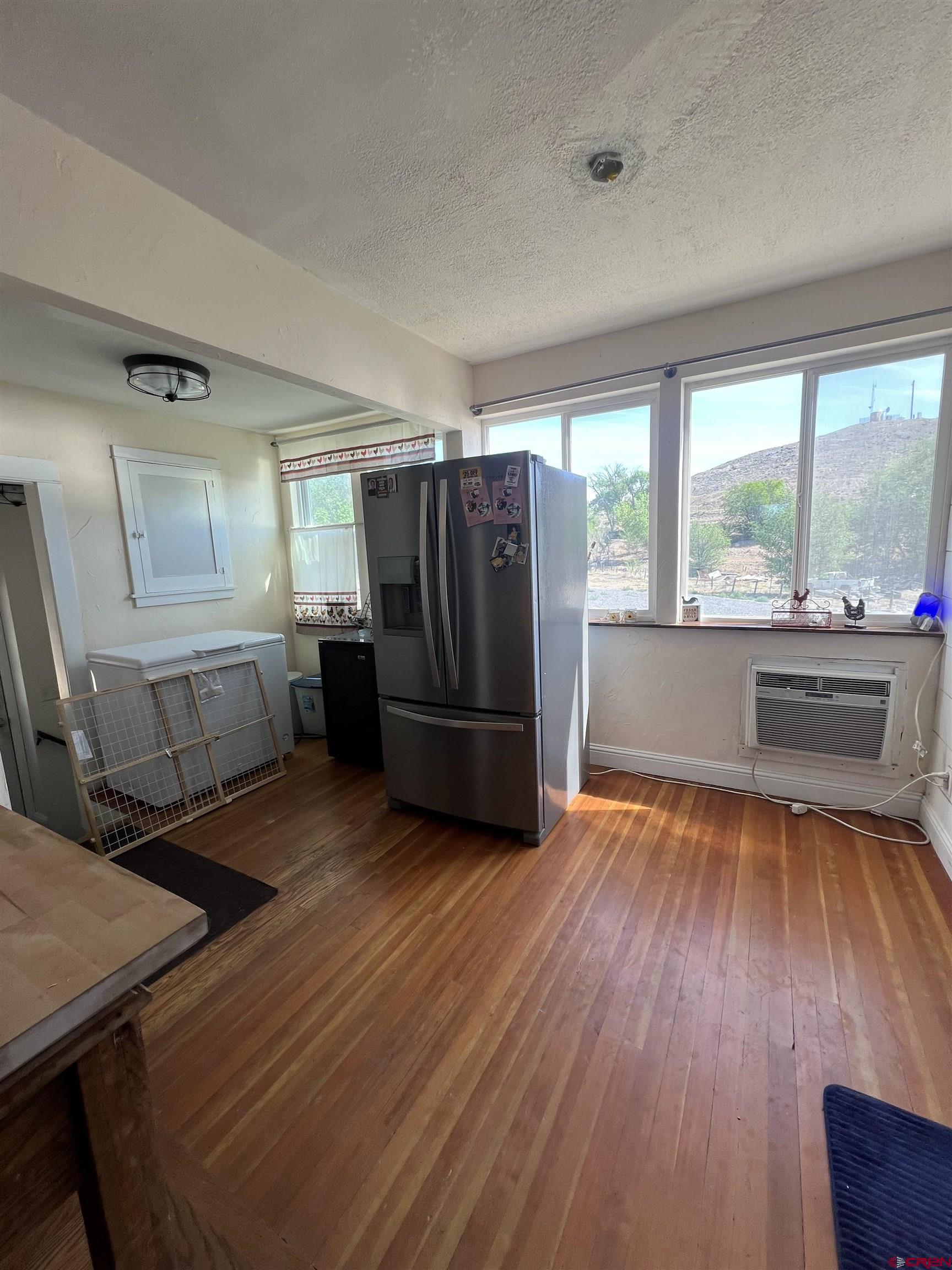 20691 Fairview Road Austin, CO 81410 - Photo 18 of 42 a kitchen with stainless steel appliances wooden floors and large window