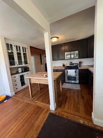 a living room with stainless steel appliances kitchen island granite countertop furniture and a kitchen view