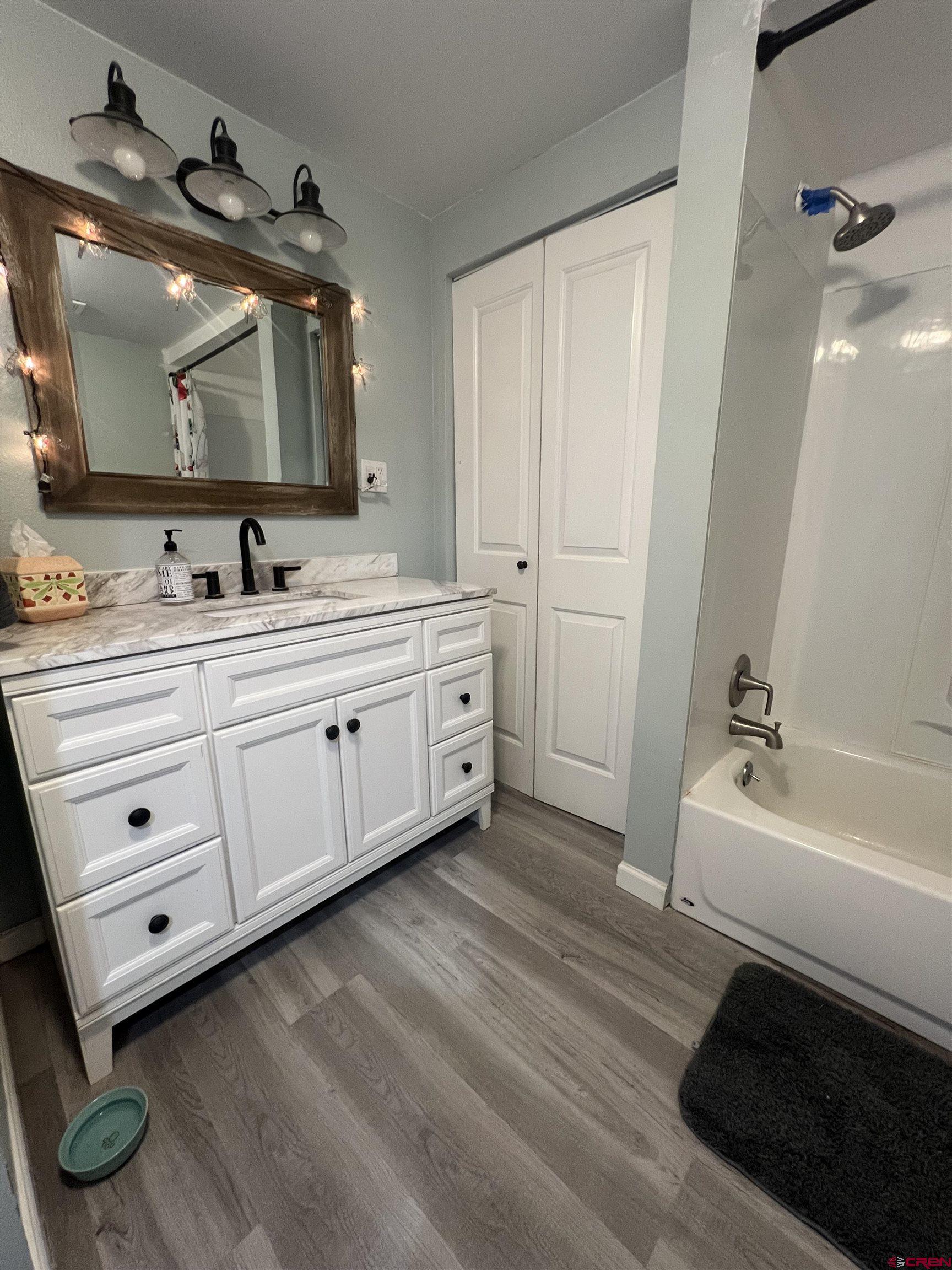 20691 Fairview Road Austin, CO 81410 - Photo 23 of 42 a spacious bathroom with a double vanity sink a mirror and a bathtub