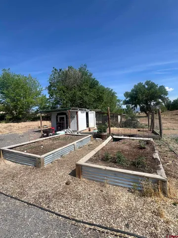 a view of a yard with cars