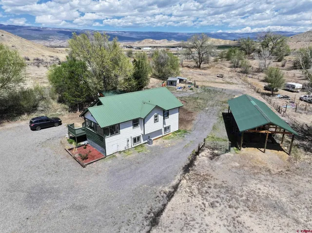 an aerial view of a house with garden space and street view