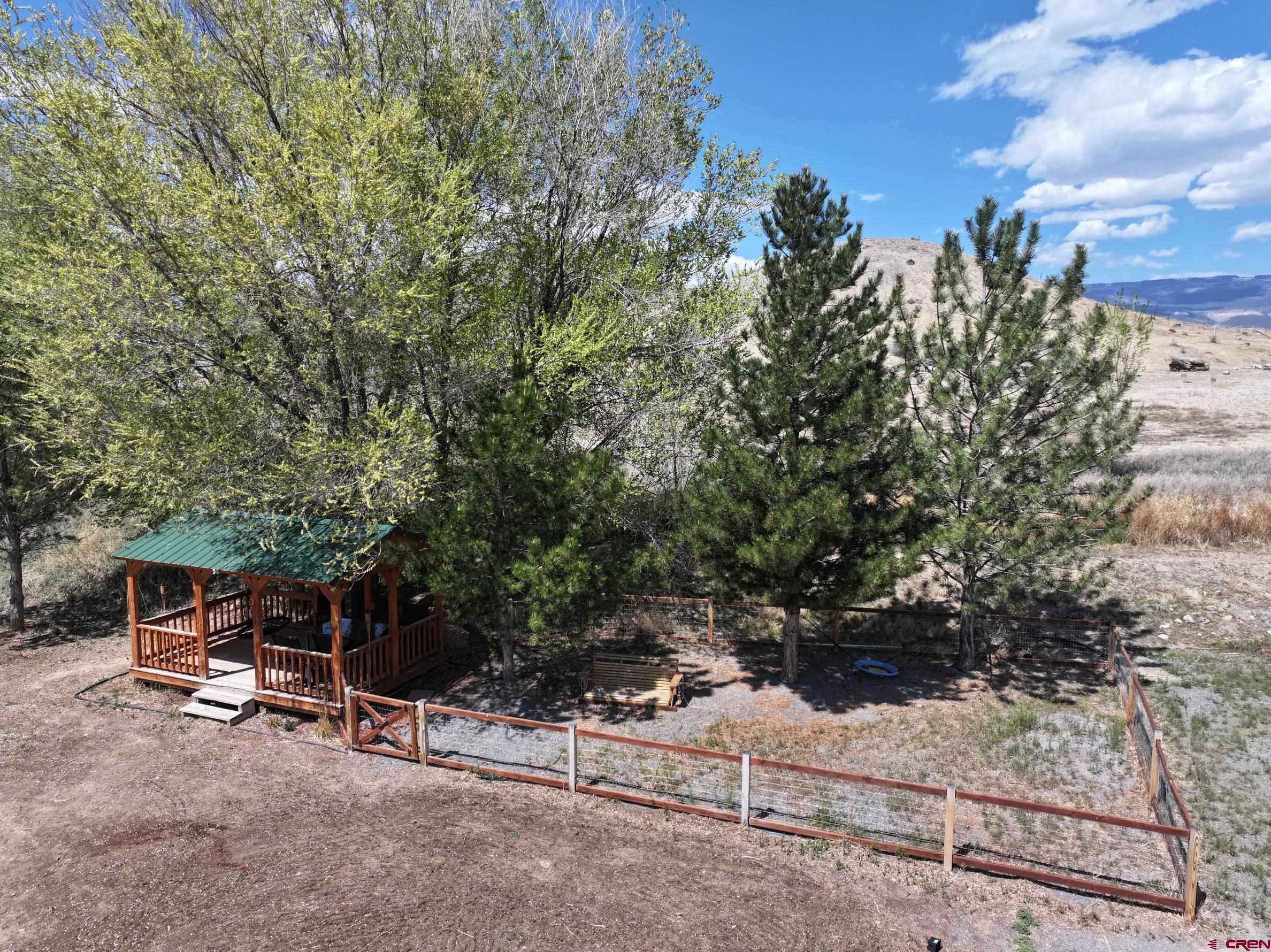 20691 Fairview Road Austin, CO 81410 - Photo 41 of 42 a backyard of a house with table and chairs
