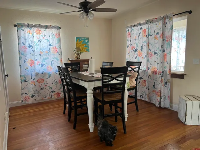a view of a dining room with furniture and wooden floor
