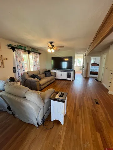 a living room with furniture and a wooden floor