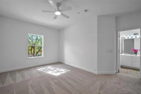 a view of room with window and ceiling fan