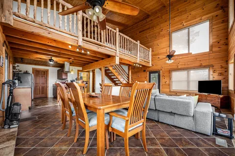 a view of hallway with wooden floor and chair
