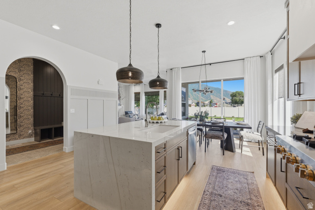 2559 West Aurora Avenue Mapleton, UT 84664 - Photo 9 of 60 Gourmet kitchen with a waterfall island, integrated sink, and pendant lighting