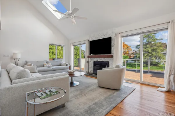 a living room with fireplace furniture and a flat screen tv