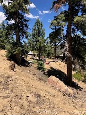 a view of a backyard with table and chairs under an umbrella